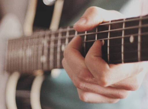 Guitar chord playing.